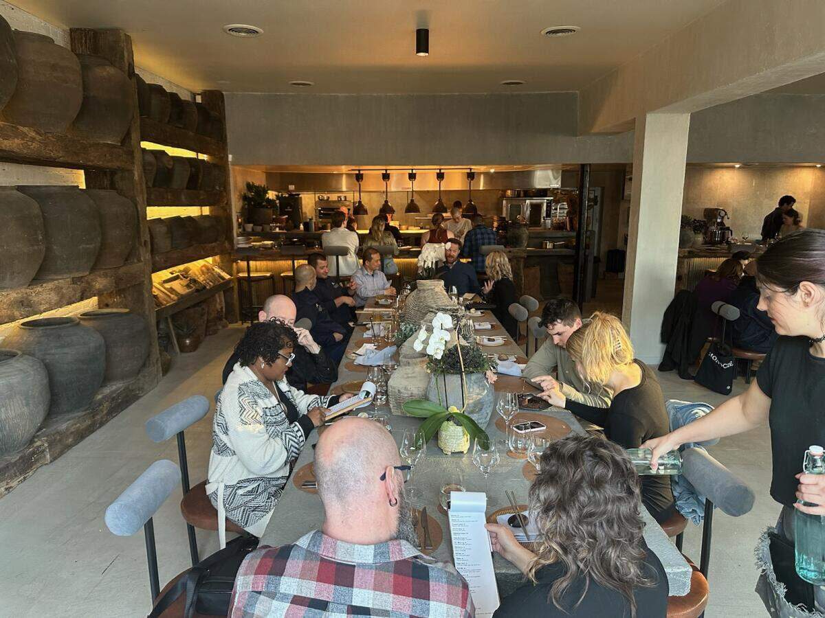 One of Noka’s three community tables has views of its open kitchen.