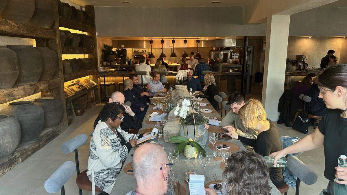 One of Noka’s three community tables has views of its open kitchen.