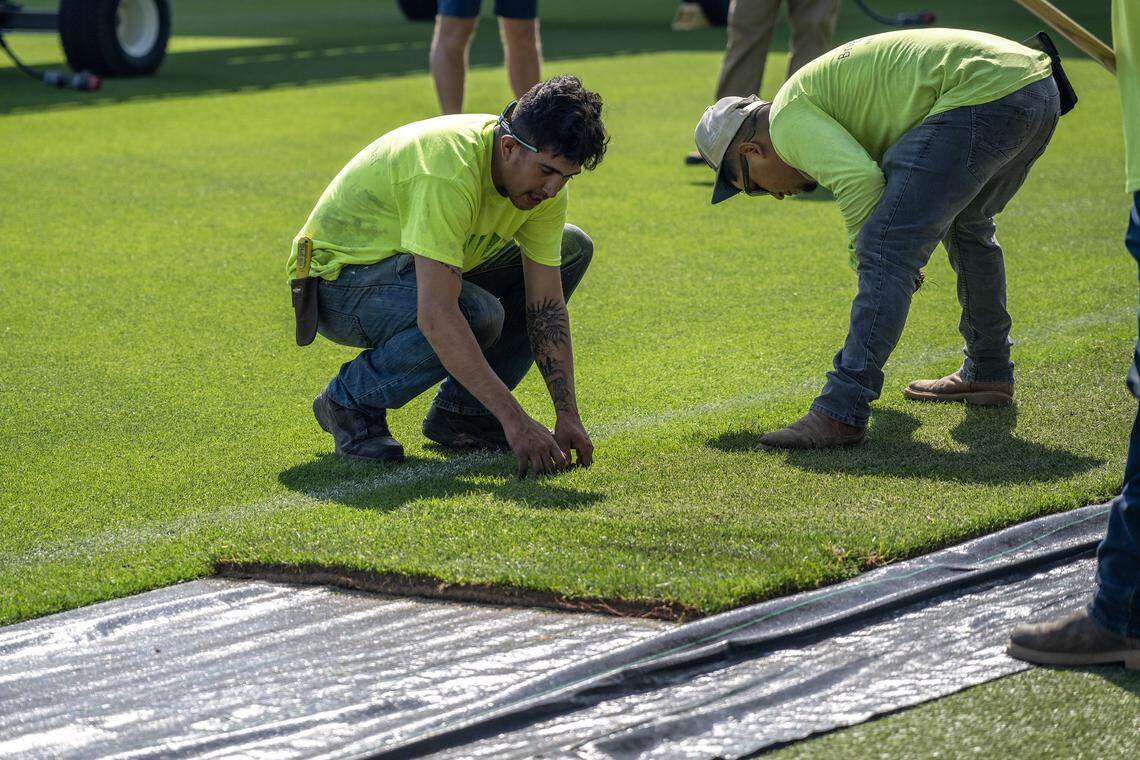 Briggs Traditional Turf Farm crews secure sod over artificial turf while converting the field for rugby at CPKC Stadium on Tuesday, April 14, 2026, in Kansas City.