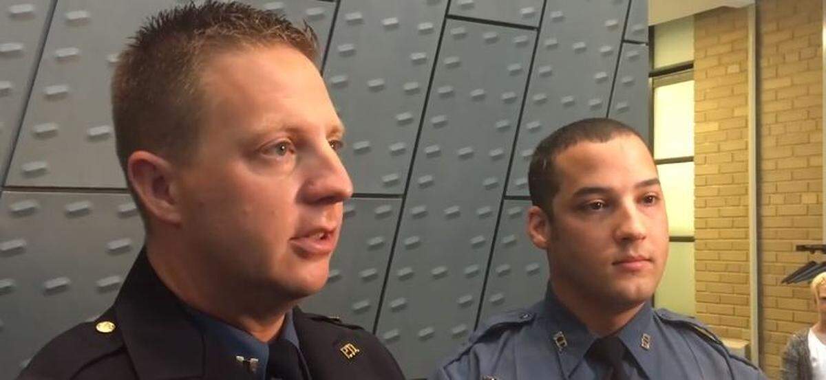 Capt. Ryan Mills, left, and Officer Aaron Smith, right, of the Kansas City Police Department, on Tuesday received the agency’s Life-Saving Award for helping a Chiefs fan who suffered a medical emergency last year at Arrowhead Stadium.