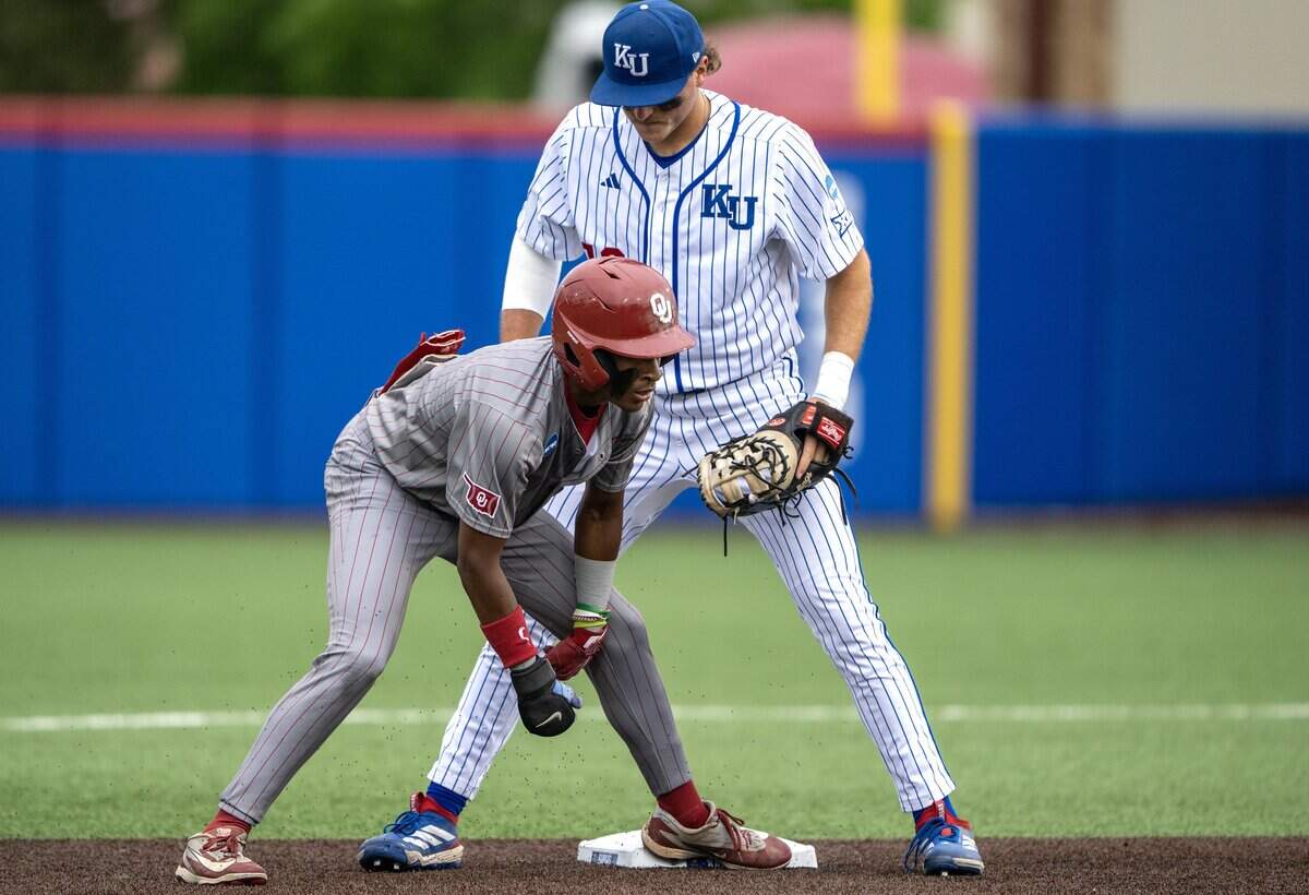 Oklahoma outfielder Jason Walk (1) slides safely back to second base as Kansas infielder Josh Dykhoff (16) receives the throw in fifth inning during an NCAA Tournament baseball game at Hoglund Ballpark on Saturday, June 6, 2026, in Lawrence.