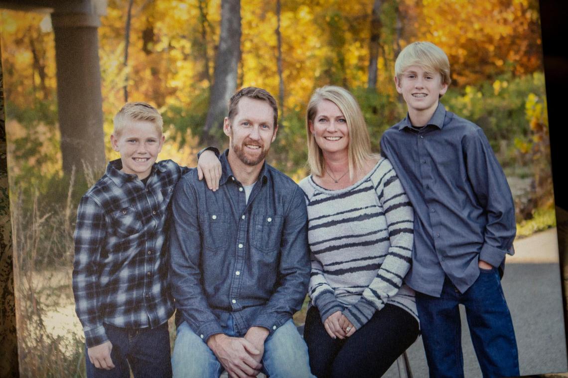 A family portrait of the Davis family rests above their fireplace: from left, Greyson, Randy, Libby and Cooper.