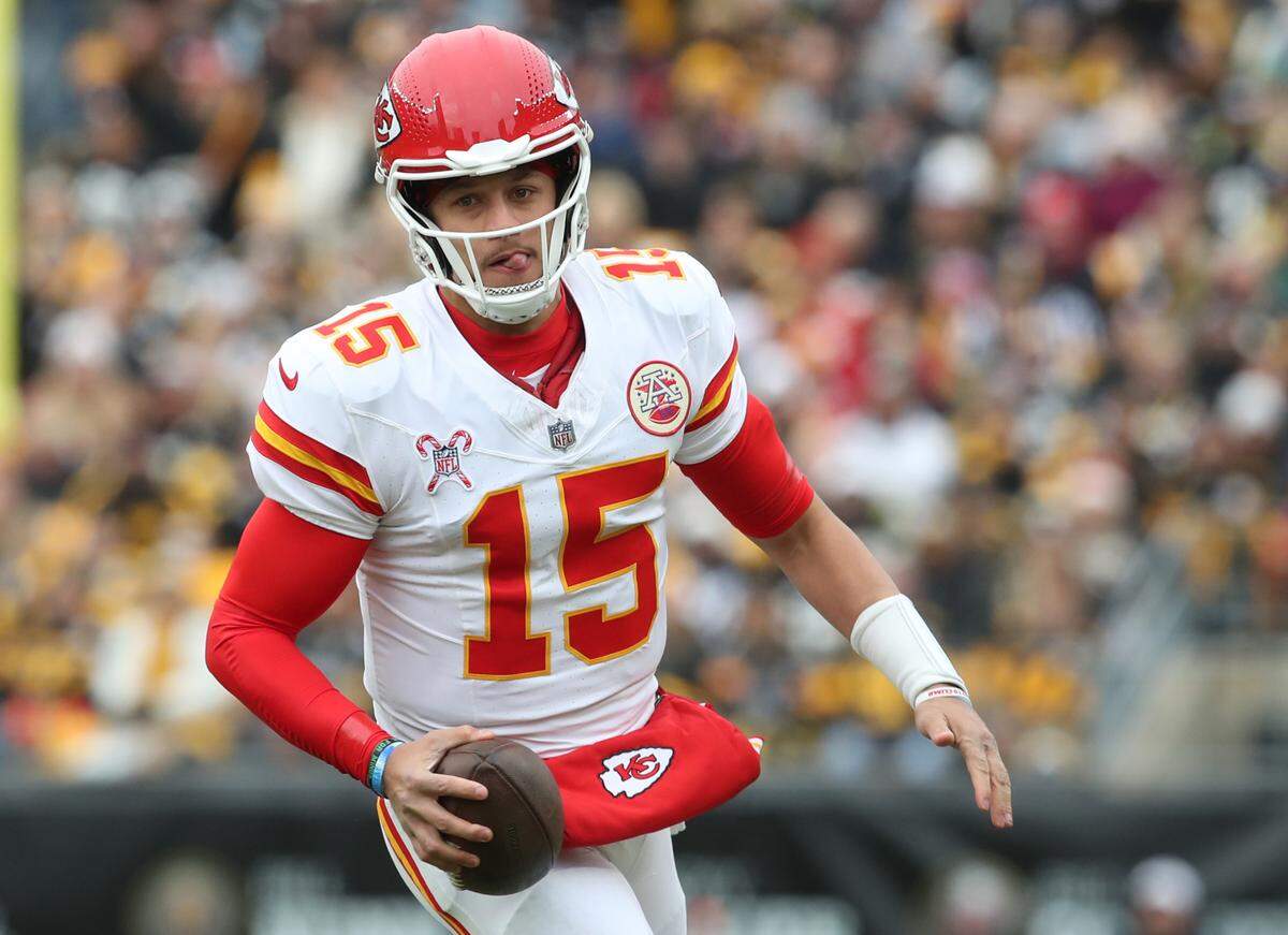 Kansas City Chiefs quarterback Patrick Mahomes runs with the ball during an NFL Week 17 game against the Steelers at Acrisure Stadium in Pittsburgh, Pennsylvania on Wednesday, Dec 25, 2024.