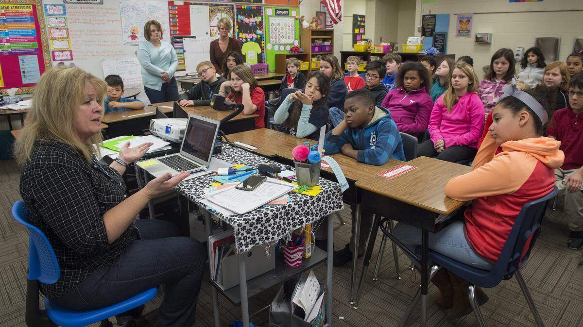 Teacher Kathy Silverman spoke with fifth-graders at Stony Point South Elementary School in Kansas City, Kan.,  as the students gathered on Jan. 20, 2017, to watch Donald Trump be sworn in as president. Kansas City, Kan., Public Schools is one of the four districts that sued the state in 2010 over education funding.