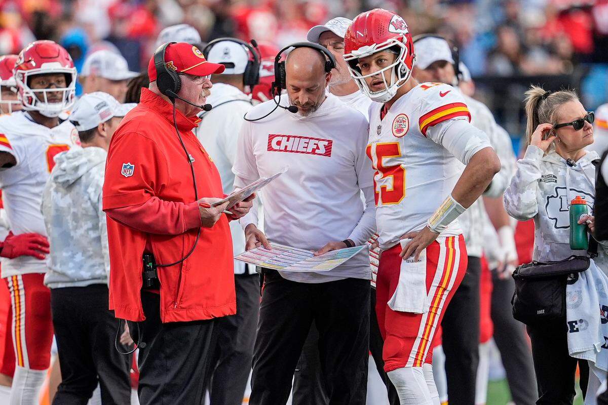 Kansas City Chiefs head coach Andy Reid talks with quarterback Patrick Mahomes (15) during a time out during the second half against the Carolina Panthers at Bank of America Stadium.