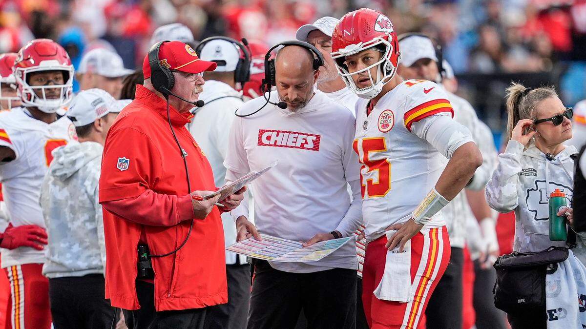 Kansas City Chiefs head coach Andy Reid talks with quarterback Patrick Mahomes (15) during a time out during the second half against the Carolina Panthers at Bank of America Stadium.