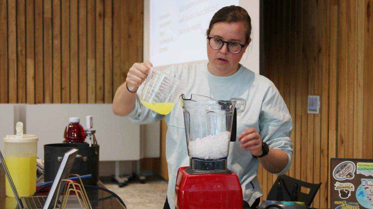 Ashley Craft demonstrates the recipe for Sleigh-Ride Slush using a Kool-Aid simple syrup as part of a program at Indian Creek Library. Craft was promoting her second book, “The Unofficial Disney Parks Drink Recipe Book.”