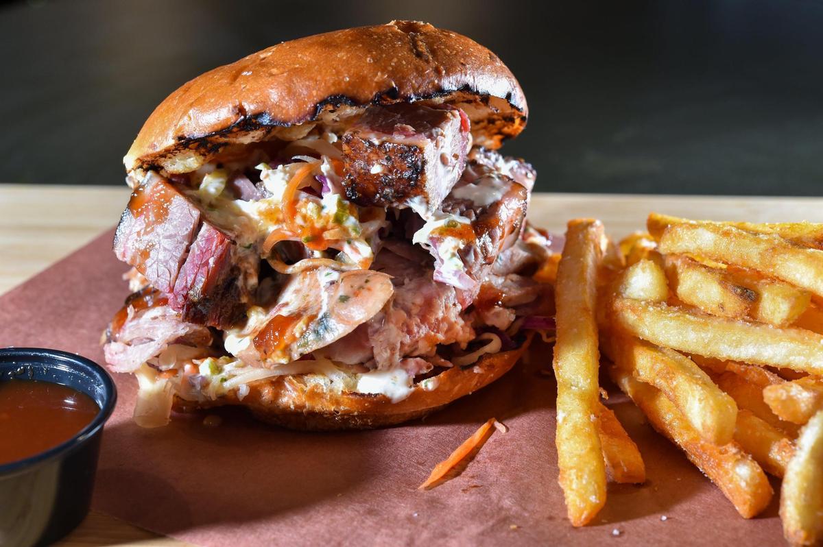 Executive Chef and Pit Master Ted Liberda is opening Buck Tui BBQ, a Thai Kansas City barbecue restaurant in the space once occupied by Plowboys Barbeque, 6737 W. 75th St. in Overland Park. On the menu, Liberda features The X Man sandwich, named after a friend’s son. The sandwich features Buck Tui brined brisket, pulled Heavenly pork, Thai sausage, BBQ sauce, papaya slaw, creamy Tiger Cry sauce on Farm To Market bun.