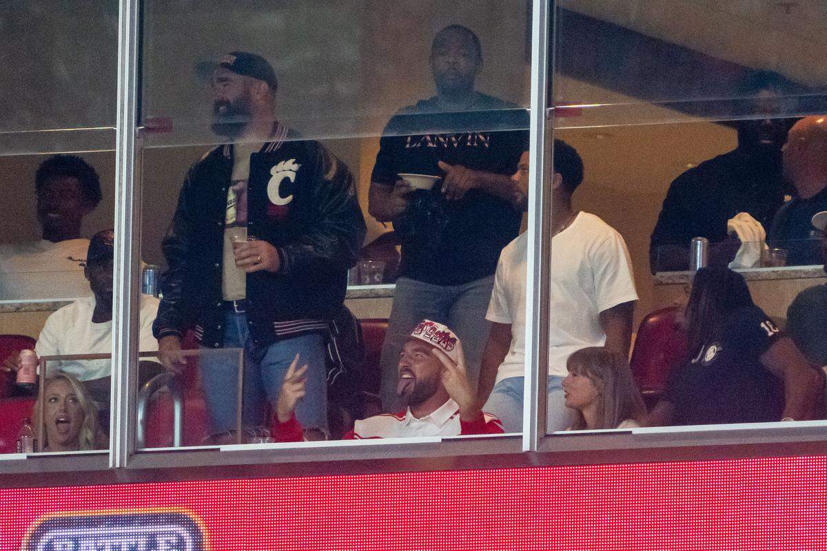 Travis Kelce and Taylor Swift look on at the end of the third quarter between the Cincinnati Bearcats and the Nebraska Cornhuskers at GEHA Field at Arrowhead Stadium. 