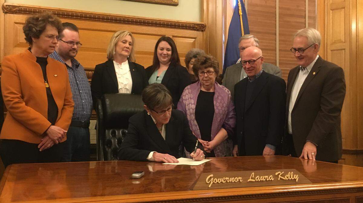 Democratic Gov. Laura Kelly signs SB 9, authorizing a payment of $115 million to the state’s retired employee pension system.