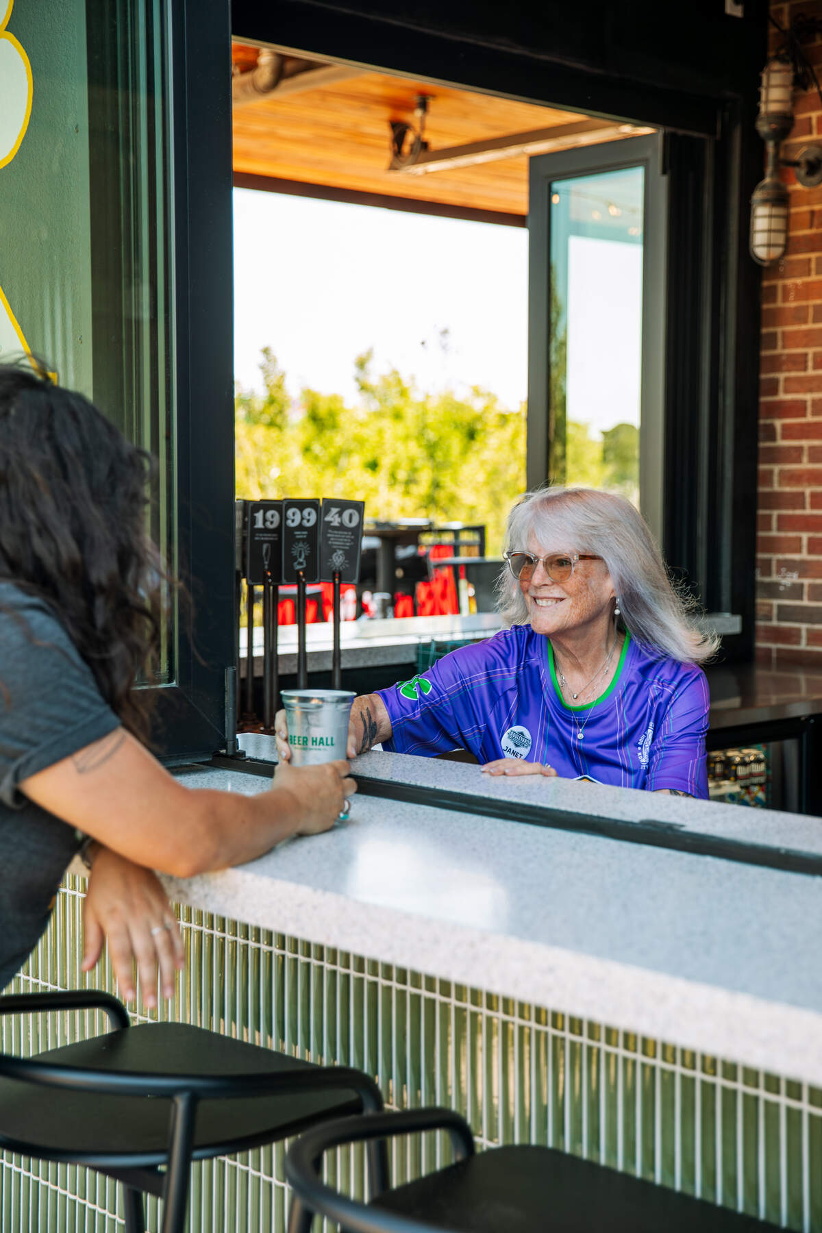 A bartender serves a customer a drink at Boulevard Brewing’s new Boulevard Yard.