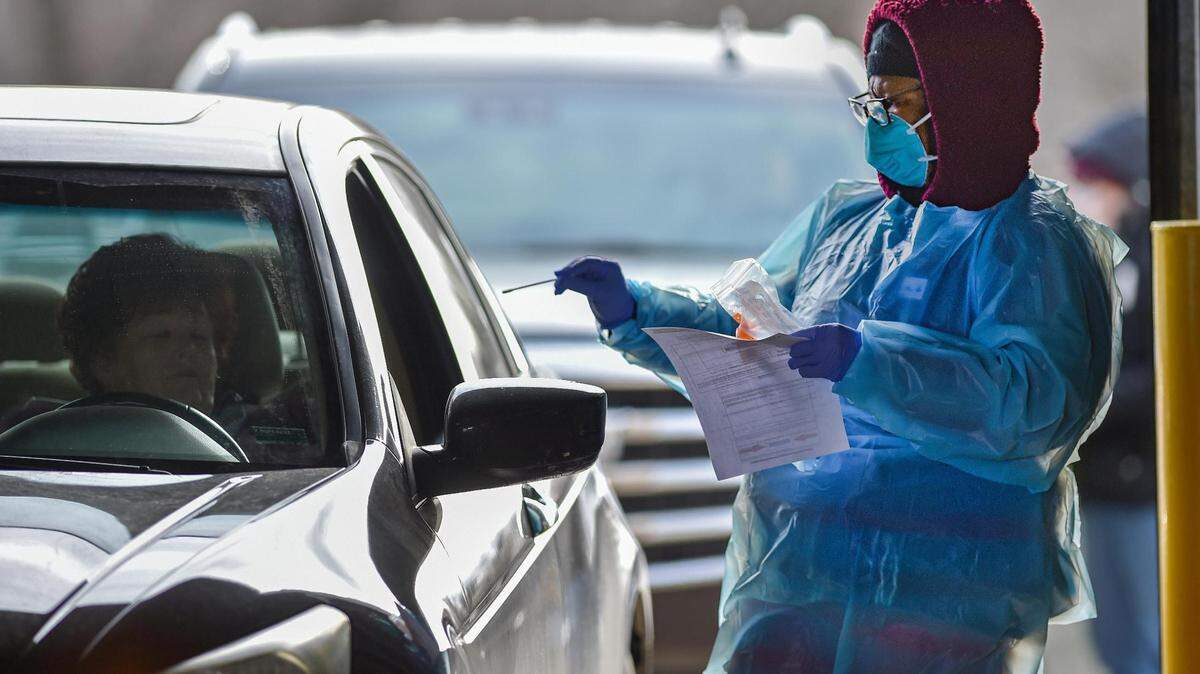 Tawonia Scott, a registered nursed, went for a nasal swab during a COVID-19 drive-thru clinic staffed by the Jackson County Health Department on Wednesday, Jan. 5, 2022, at 616 N.E. Douglas St., in Lee’s Summit. The clinic, which requires an appointment, offered 300 test appointments during the event. Since the surge of the omicron variant, testing for the coronavirus has been in high demand.