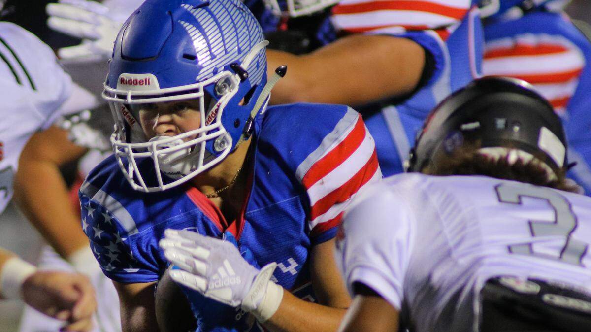 Liberty running back Wentric Williams III looks for a hole against the Lee’s Summit North defense on Friday night at Liberty. The Blue Jays overcame a 14-point deficit in the second half to win 38-35.