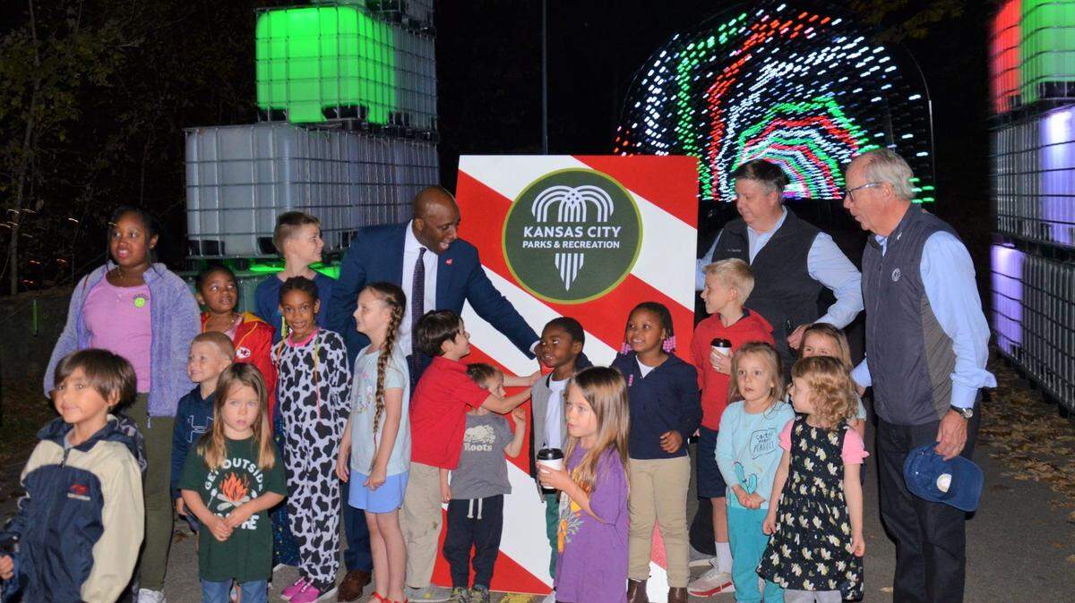 Mayor Quinton Lucas (left) and former parks board members Scott Wagner and Jack Holland (far right) with children at the Cliff Drive Winter Magic lighting ceremony in November 2022.