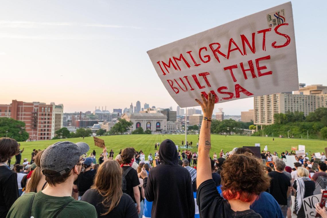 Several hundred people stand on the steps of the Liberty Memorial during a Shut Down ICE protest in Kansas City on Tuesday, June 10, 2025. People held signs and flags and chanted in support of immigrants and against the Trump administration’s immigration policies.