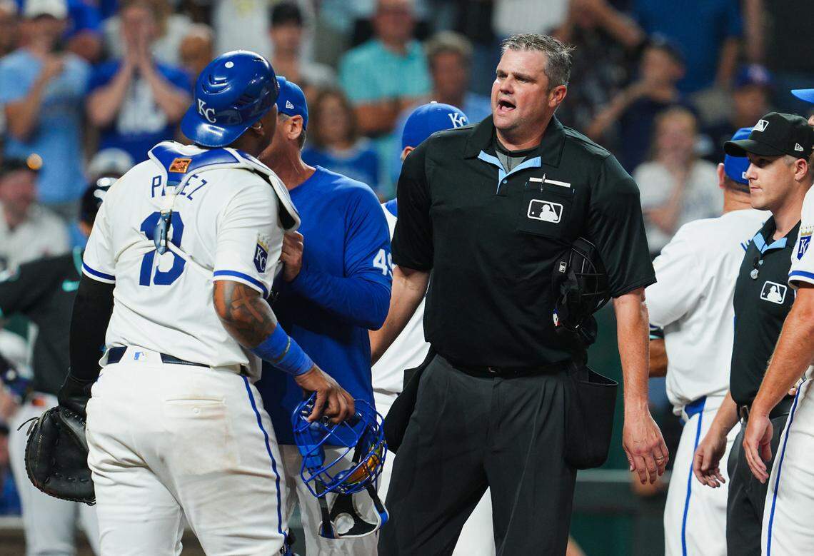 Home plate umpire Jordan Baker (71) talks with Kansas City Royals catcher Salvador Perez (13) during the seventh inning against the Arizona Diamondbacks at Kauffman Stadium on Jul 22, 2024 in Kansas City, Missouri, USA.