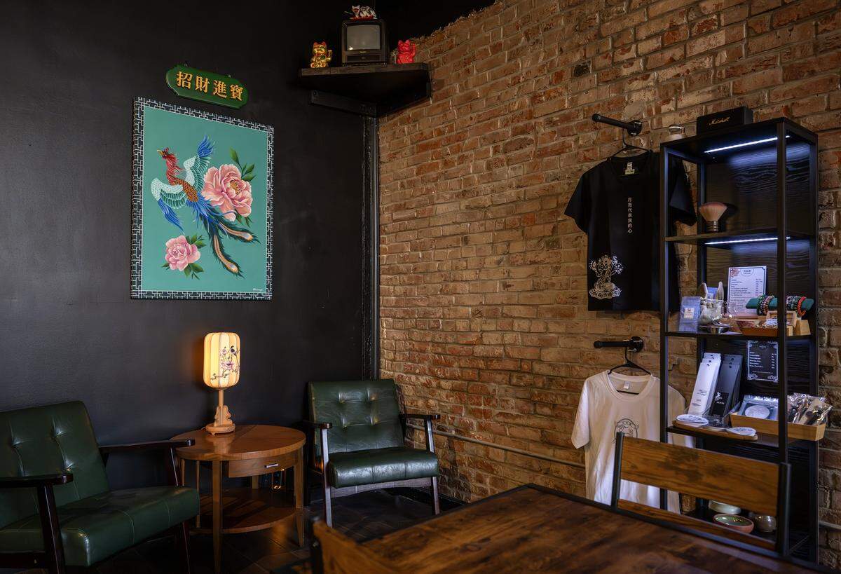 A small display nook featuring a painting of a Chinese phoenix, lucky cat figurines and merchandise is seen at Moon Bar KC on Tuesday, Dec. 16, 2025, in Kansas City.