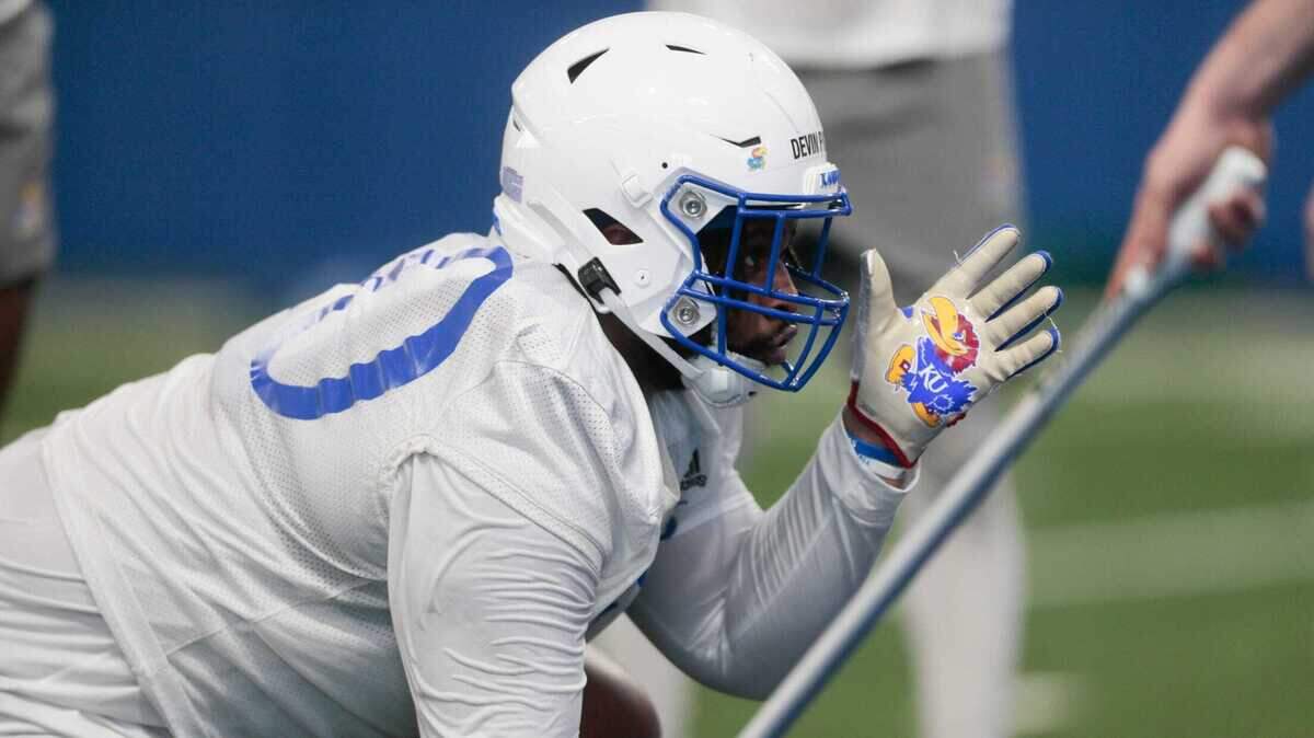 Kansas redshirt-senior defensive lineman Devin Phillips (40) works on drills during a spring 2023 practice at KU’s indoor practice facility.