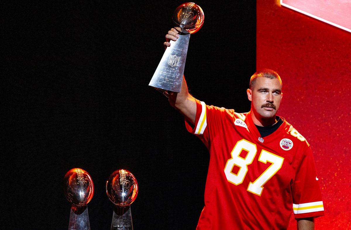 Kansas City Chiefs tight end Travis Kelce hoists one of the organization’s three Lombardi Trophies during the Chiefs’ annual Kickoff Luncheon at the Loews Hotel on Thursday, Aug. 24, 2023, in Kansas City.