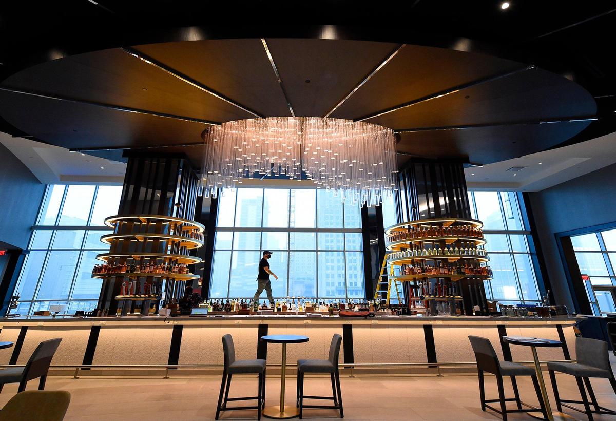 The hotel features Bar Stilwell, located in the lobby, where bartender Garrett Gunderson worked to stock the curved shelving. The bar, which will follow social distancing guidelines, will offer local spirits as well as craft cocktails.