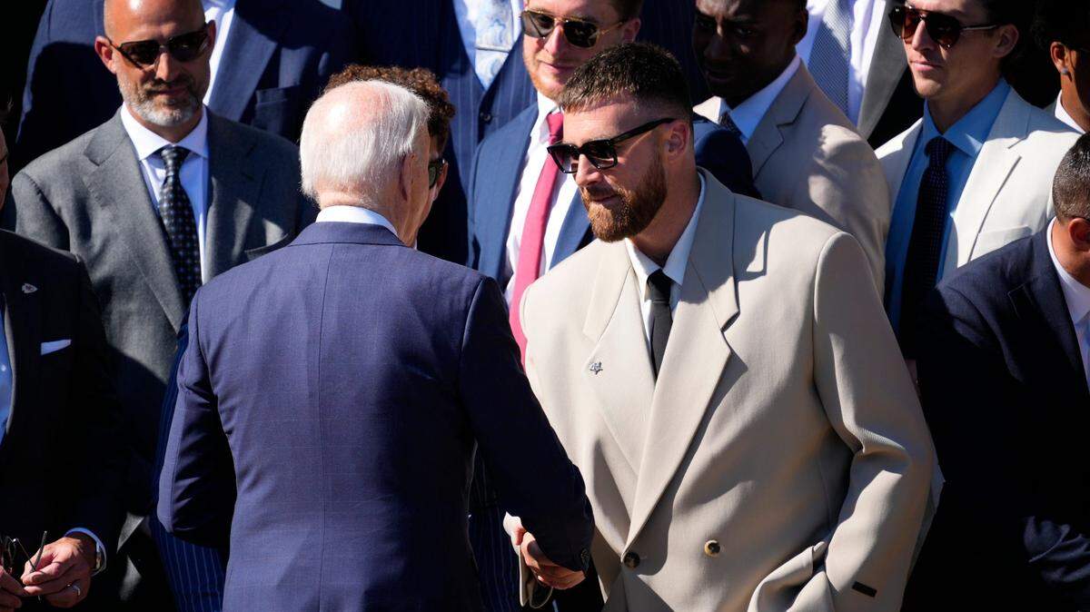 President Joe Biden shakes hands with Kansas City Chiefs tight end Travis Kelce during the team’s visit to the White House on May 31, 2024.