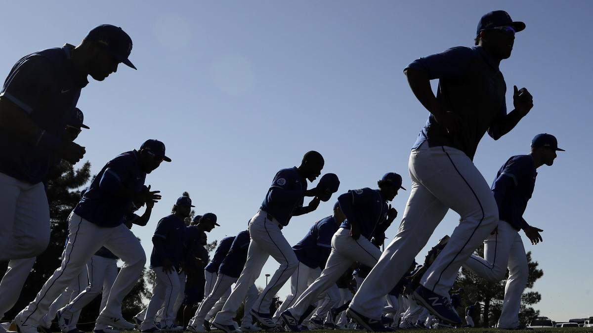 Kansas City Royals players run during spring training baseball practice Monday, Feb. 17, 2020, in Surprise, Ariz. (AP Photo/Charlie Riedel)