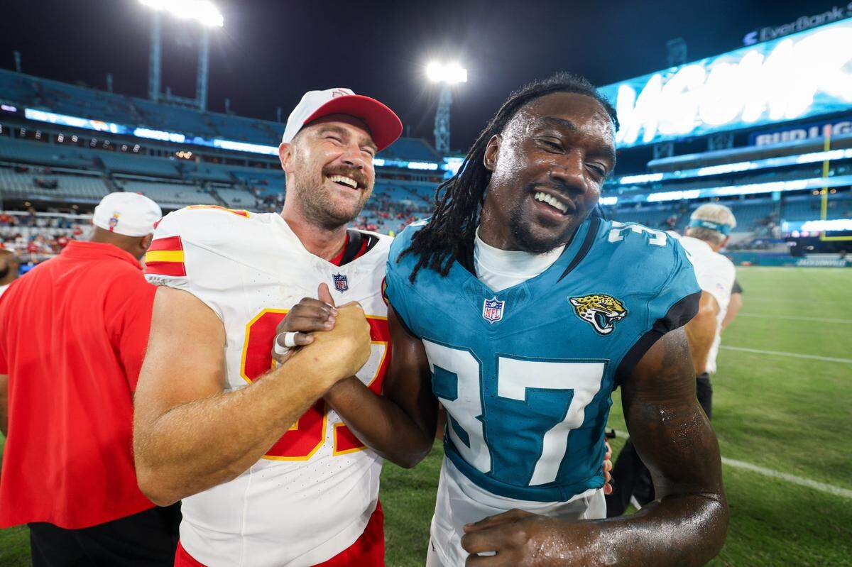 Kansas City Chiefs tight end Travis Kelce (87) greets Jacksonville Jaguars cornerback Tre Flowers (37) after a preseason game at EverBank Stadium.