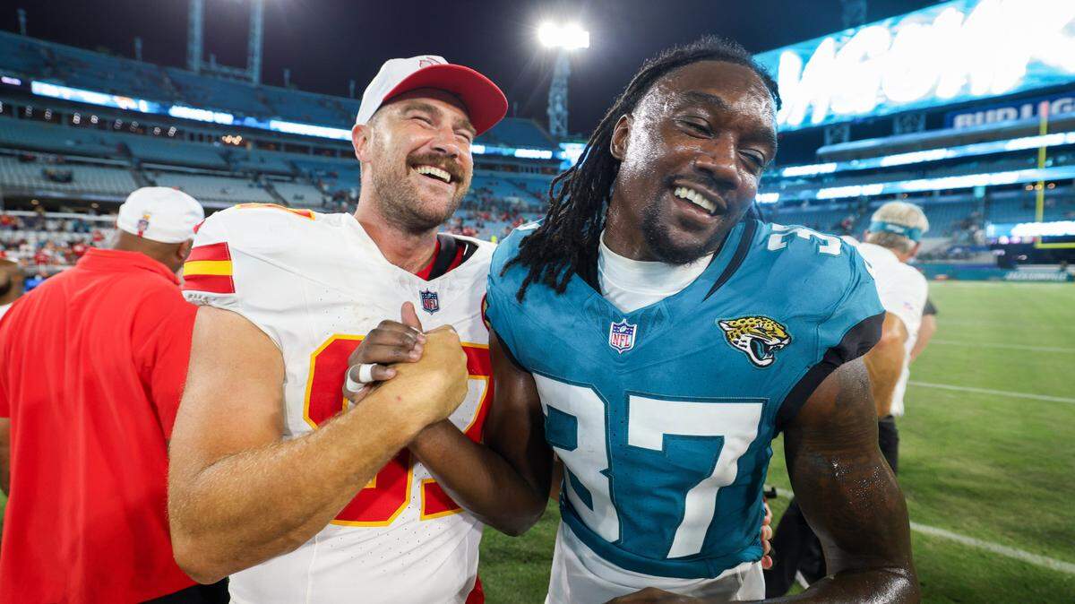 Kansas City Chiefs tight end Travis Kelce (87) greets Jacksonville Jaguars cornerback Tre Flowers (37) after a preseason game at EverBank Stadium.