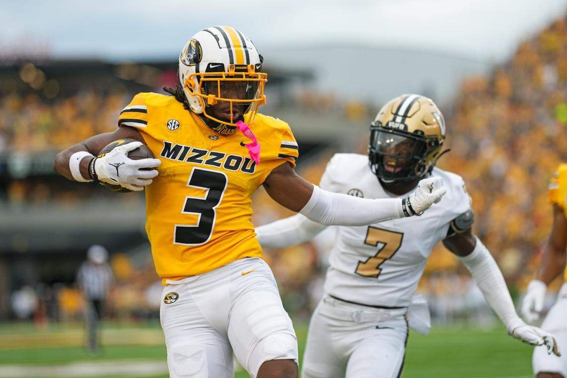 Missouri Tigers wide receiver Luther Burden III (3) scores a touchdown against Vanderbilt Commodores safety Marlen Sewell (7) during the first half at Faurot Field at Memorial Stadium on Sept. 21, 2024.