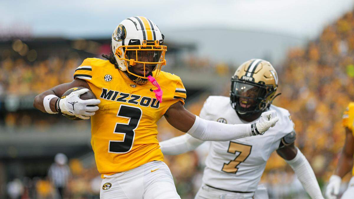 Missouri Tigers wide receiver Luther Burden III (3) scores a touchdown against Vanderbilt Commodores safety Marlen Sewell (7) during the first half at Faurot Field at Memorial Stadium on Sept. 21, 2024.