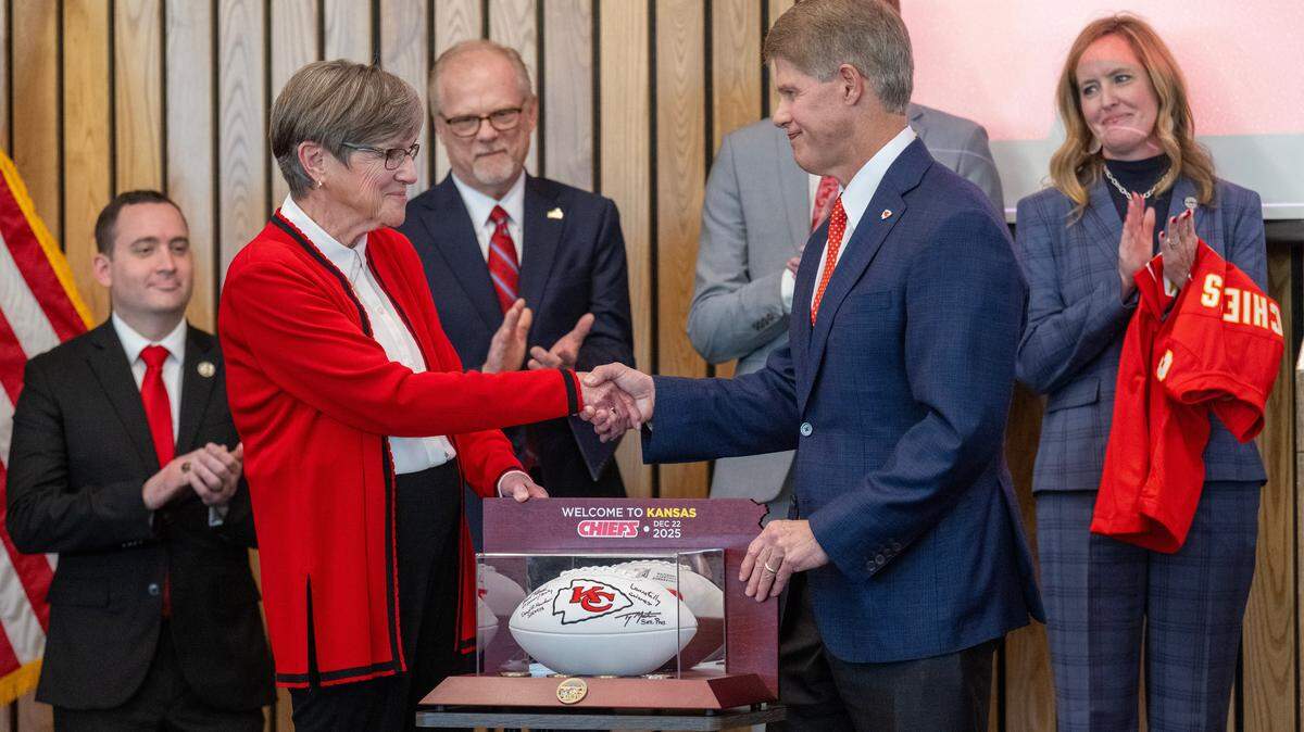 Kansas Governor Laura Kelly announced Monday, Dec. 22, 2025, in Topeka that the Kansas City Chiefs will build their new stadium in Kansas City, Kansas. Kelly presented Chiefs CEO Clark Hunt with a football as others looked on during the announcement.