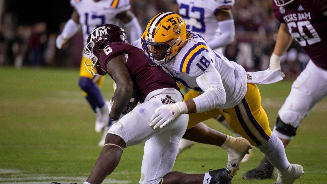 Nov 26, 2022; College Station, Texas, USA; LSU Tigers defensive end BJ Ojulari (18) and Texas A&M Aggies running back Devon Achane (6) in action during the game between the Texas A&M Aggies and the LSU Tigers at Kyle Field. Mandatory Credit: Jerome Miron-USA TODAY Sports