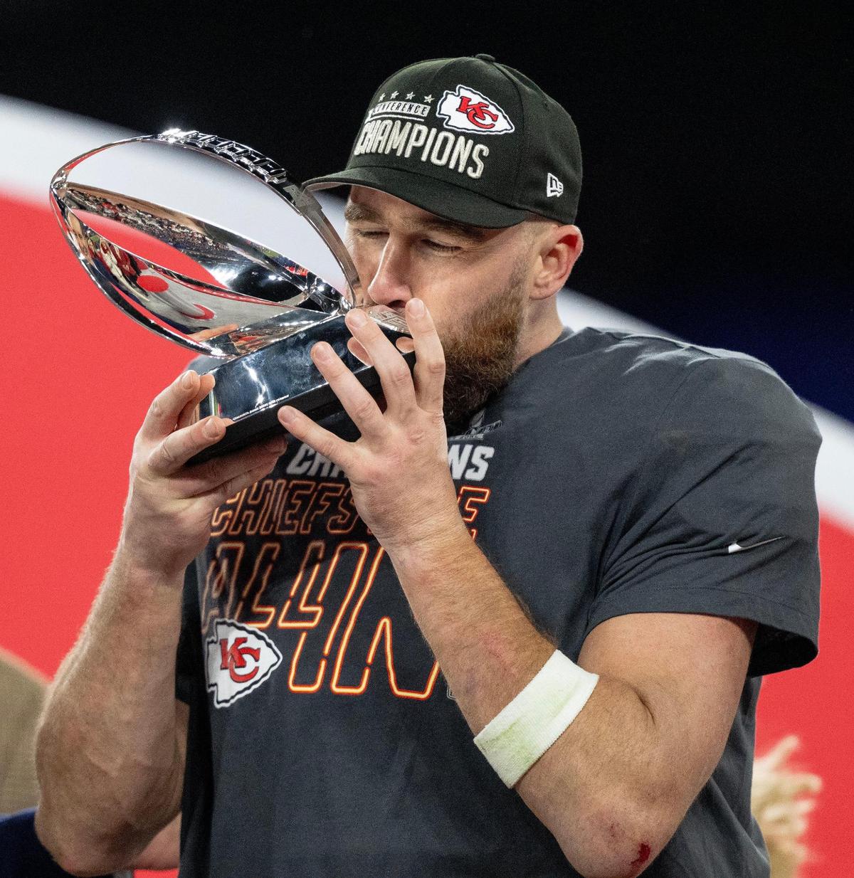 Kansas City Chiefs tight end Travis Kelce (87) kisses the Lamar Hunt Trophy after the Chiefs defeated the Baltimore Ravens 17-10 in the AFC Championship Game on Sunday, Jan. 28, 2024, in Baltimore.