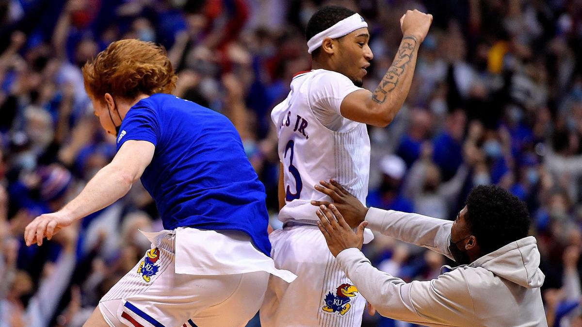After hitting the game-winning shot in Kansas’ 62-61 win over Iowa State on Tuesday night, Dajuan Harris (center) celebrated with teammates Chris Teahan (left) and Kyle Cuffe.