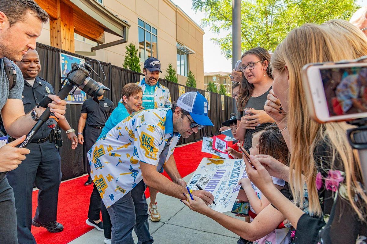 Paul Rudd obliged his fans with an autograph along the red carpet Saturday. Behind him, from left, Overland Park police officer John Lacy, Gloria Rudd (Paul’s mom) and Jason Sudeikis.