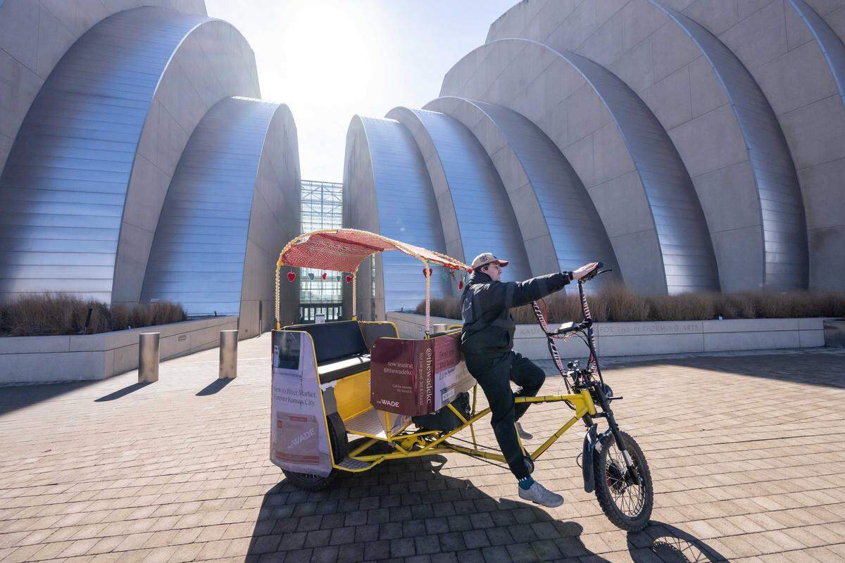 Mark Manning rides past the Kauffman Center of Performing Arts. “It’s going to be a huge, once in a generation, once in a lifetime opportunity,” Madden said about the World Cup coming to Kansas City. 