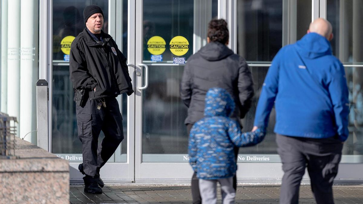 A Crown Center security guard turns a family away from the shopping center on Thursday, Jan. 18, 2024, in Kansas City. The mall remains closed after a Wednesday night shooting inside left six injured.
