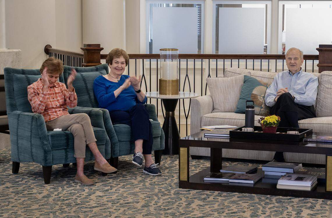 Residents Linda Jenson, Mary Kay and Charles Horner applaud after Naren Palomino Pardo, a graduate piano student, who is an artist-in-residence at Claridge Court, played the piano for residents on Monday, Oct. 13, in Prairie Village.