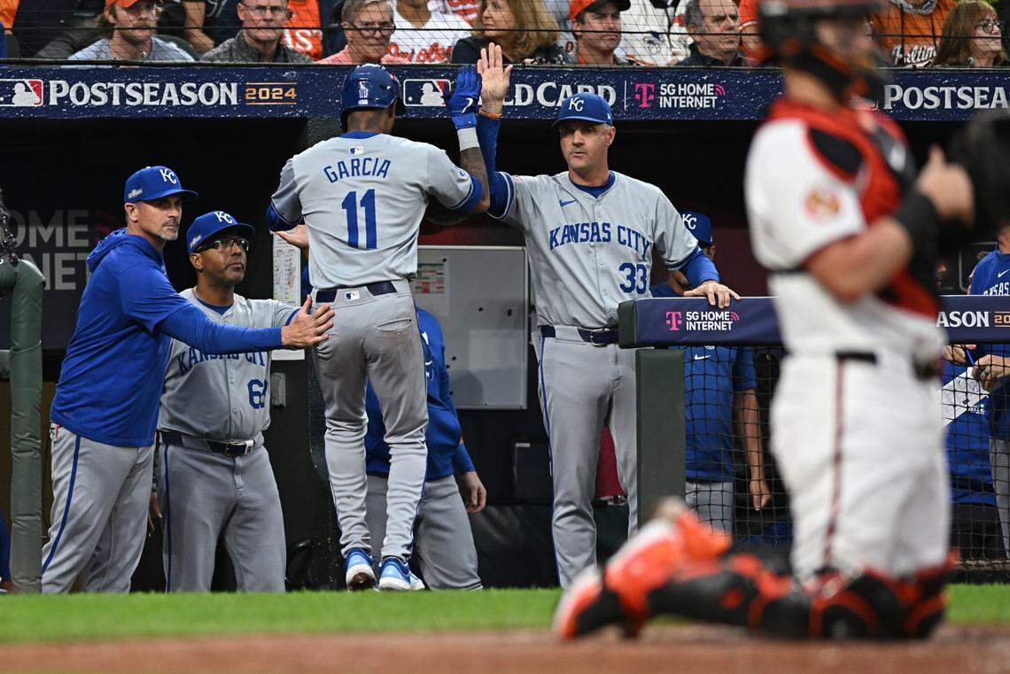 Kansas City Royals third baseman Maikel Garcia (11) scores a run and celebrates with manager Matt Quatraro (33) against the Baltimore Orioles in the sixth inning of Game 1 of the Wild Card round at Oriole Park at Camden Yards on Oct. 1, 2024.