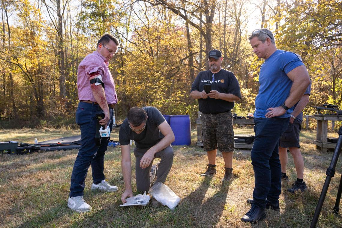 Missouri Democratic candidate for U.S. Senate Lucas Kunce applies first aid to KSHB 41 reporter Ryan Gamboa after Gamboa was struck by ricochet from a bullet fragment shot from a gun handled by Kunce during a sport shooting campaign event with former Republican representative Adam Kinzinger on Tuesday, Oct. 22, 2024 in Holt, Missouri.