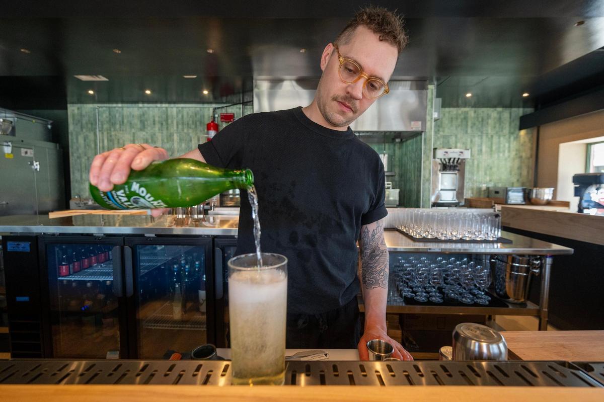 Drew Little, a partner at Anjin, a Japanese bar and restaurant, 1708 Oak St., makes a Japanese Highball.