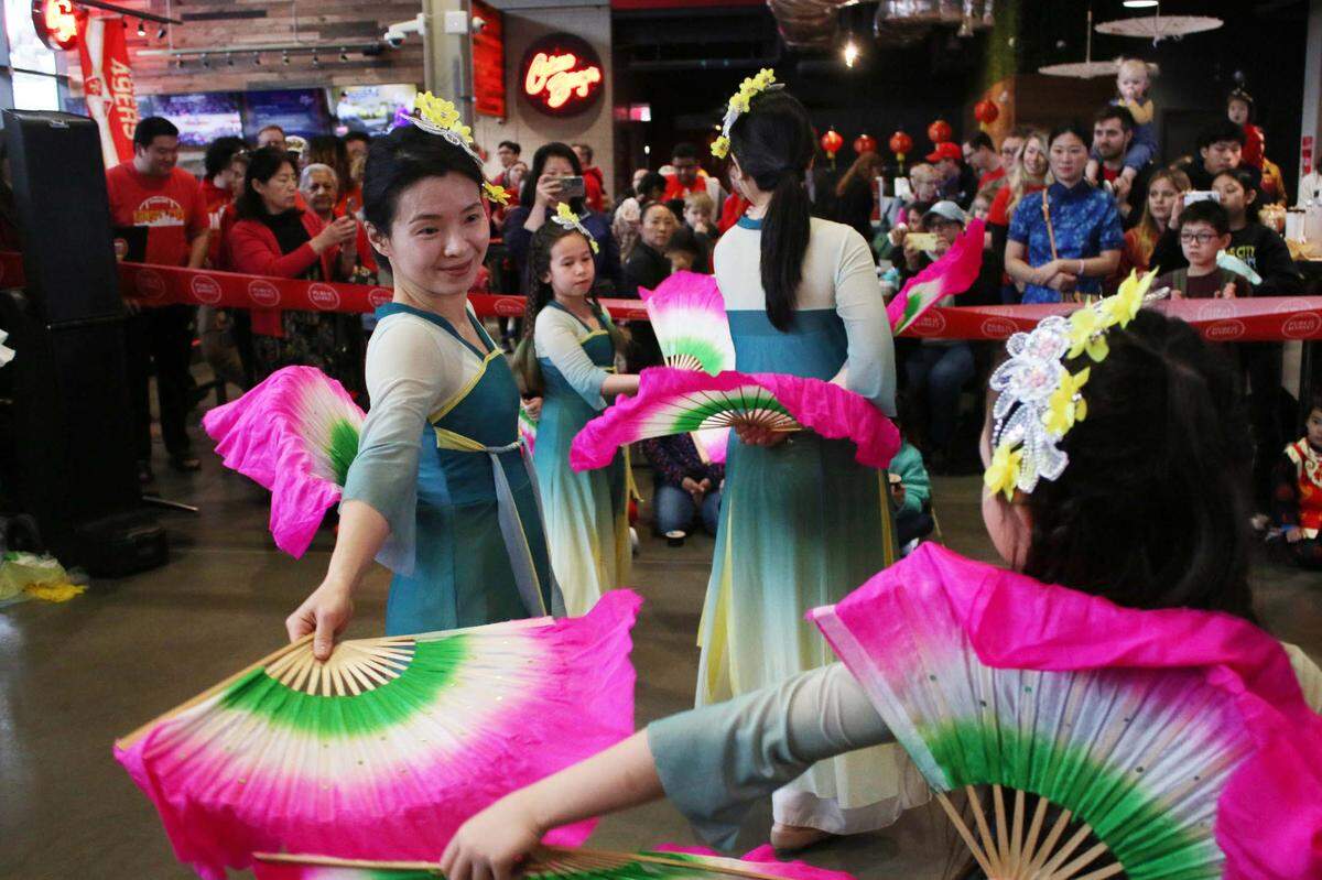 Chinping Tsai dances with the other members of the HK Chinese Folk Dancers at the Lenexa Public Market’s Lunar New Year celebration.