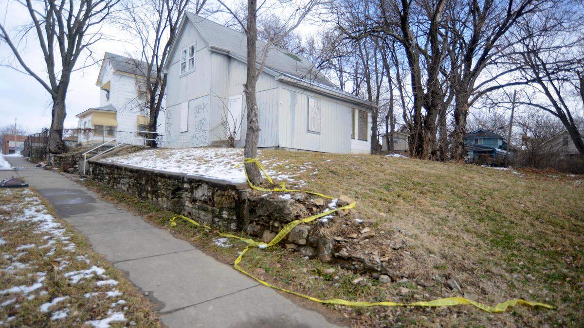 Crime scene tape remains tied to a tree in the 2400 block of Kensington Avenue in Kansas City, where Tina Moore, 36, was found fatally shot at a home Jan. 10.