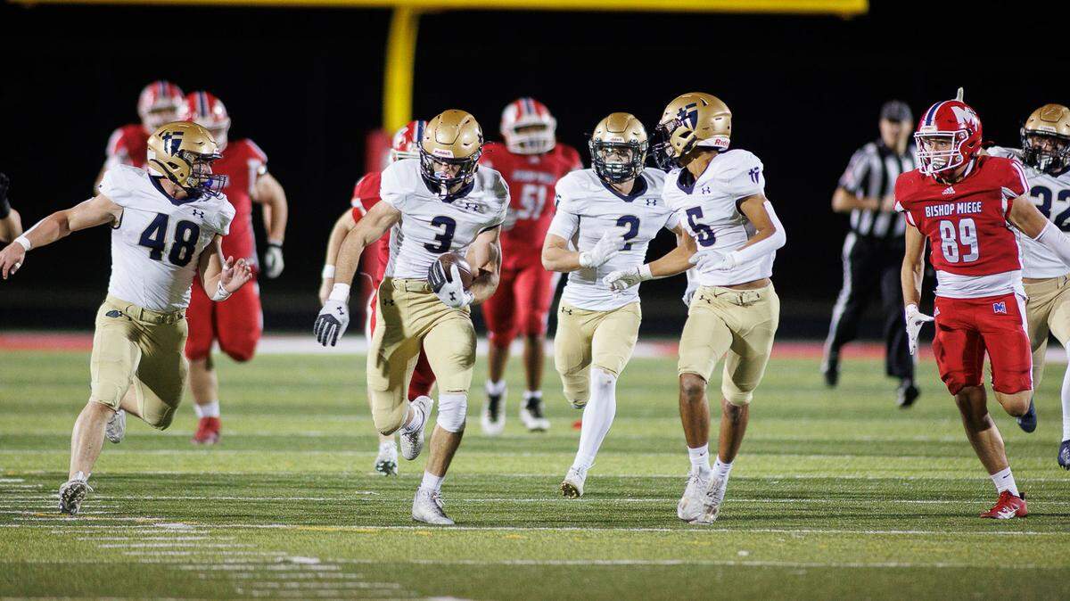 Senior defensive end Owen Charlton (No. 3) returns a blocked field goal for a touchdown to spark St. Thomas Aquinas to a 14-7 victory over Bishop Miege on Friday night.