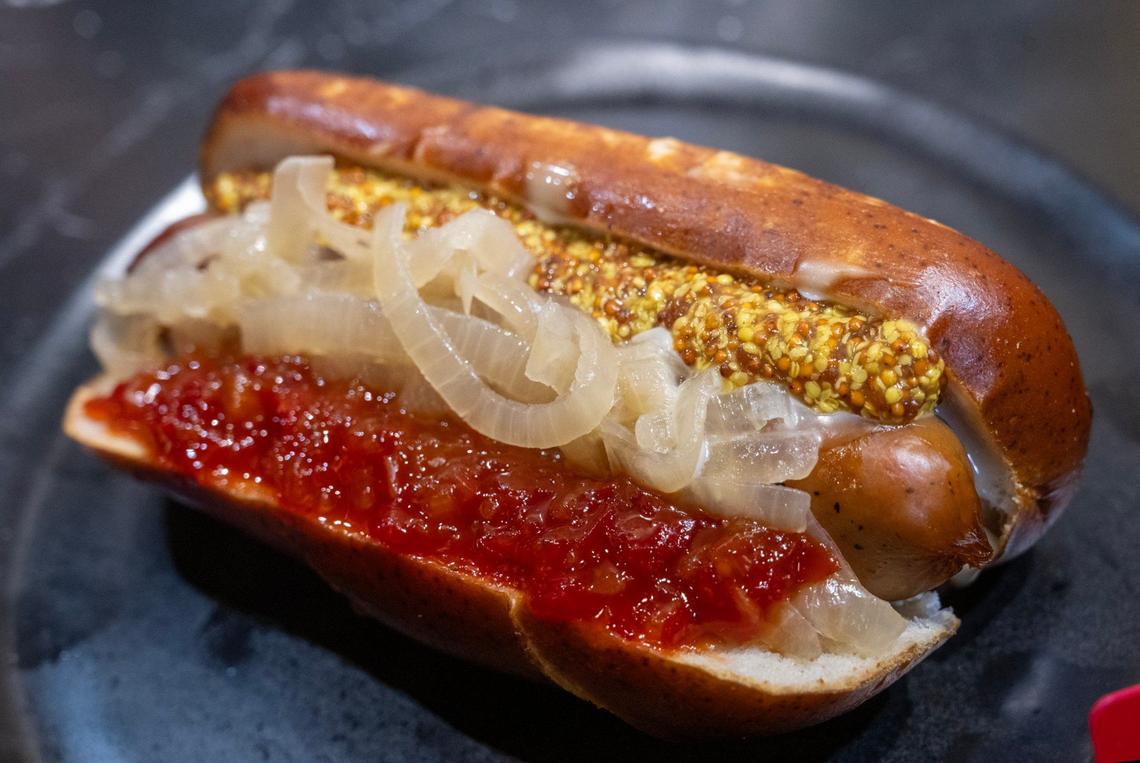Bavarian Brat, a grilled brat in a soft pretzel bun, with white cheese sauce, topped with beer braised onions, stone ground mustard and sweet pepper relish, is a new offering from Aramark for the general concessions at GEHA Arrowhead Stadium.