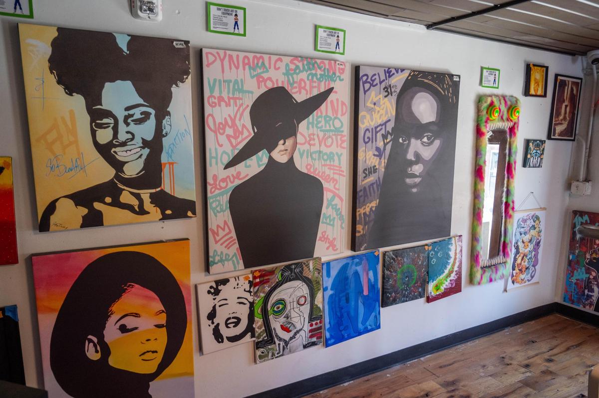 Art hangs on the walls in the more private sitting area at Otaku Lounge. Otaku hosts the work of several local artists and helps to sell their work.