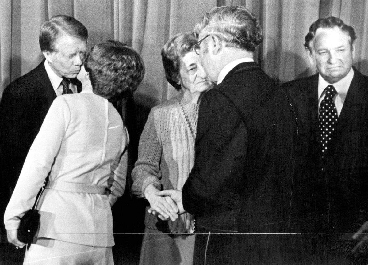 Jimmy Carter, the Democratic Presidential candidate, greeted one of about 250 people who went through a reception line before he spoke last night at a memorial dinner for the late Rep. Jerry Litton at the Radisson Muehlebach Hotel. Next to Carter were Mr. and Mrs. Charley Litton, the parents of Litton.