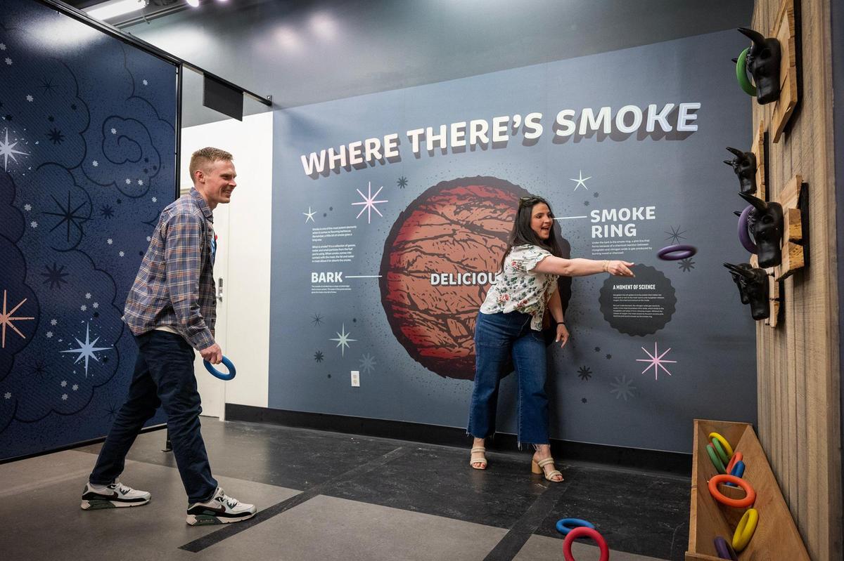 Nick and Becca Hageman of Leawood, played the Smoke Ring Toss during a visit to the new Museum of BBQ.