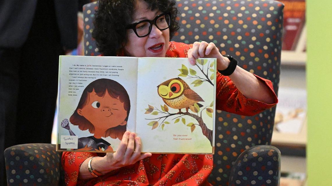 Justice Sotomayor held up her book showing the illustrations by Rafael Lopez as she read out loud to children in Kansas City on Friday.