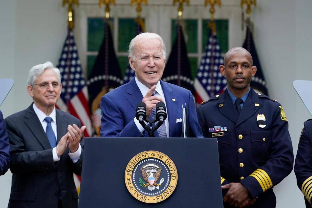 Attorney General Merrick Garland, left, and Kansas City Interim Police Chief Joe Mabin listened as President Joe Biden spoke in the Rose Garden of the White House in May during an event to highlight state and local leaders who are investing American Rescue Plan funding.